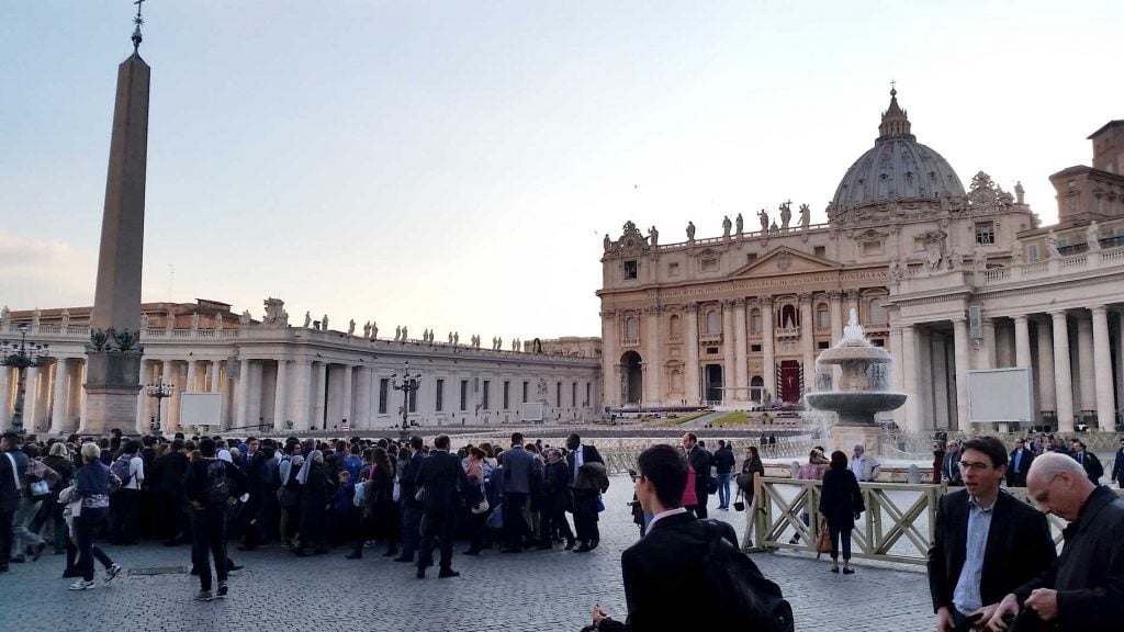 Picture of St Peter's Square with a large crowd. How to avoid the queues at all of Rome's major attractions.