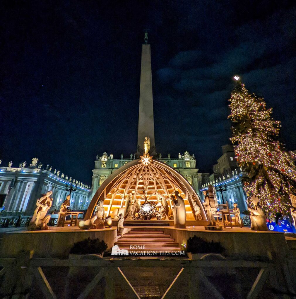 Nativity scene in wood in St Peter's Square next to a Christmas tree