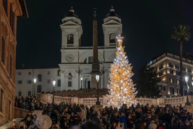 The Spanish Steps at night, with a lit Christmas tree in front of The Trinita dei Monti church.